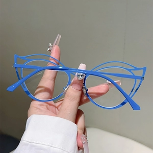 Detailed view of the hollow cat-eye metal frame with a cobalt blue finish and clear lenses
