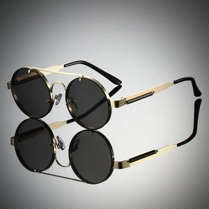 Detail view of steampunk round sunglasses featuring gold metal frame and spring hinges