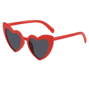 Detailed view of fashionable red heart-shaped sunglasses with dark UV protection lenses