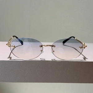 Lunettes de soleil ovales sans monture, charnière à billes dorée et verres dégradés