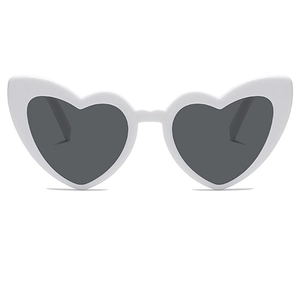 Detail shot of heart-shaped white plastic sunglasses with dark UV protection lenses
