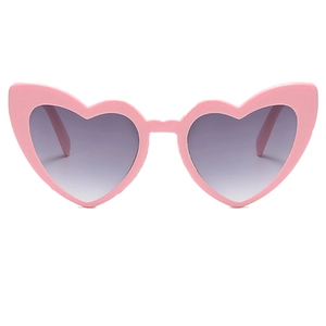 Close-up of pink heart-shaped sunglasses with gradient grey lenses for party style