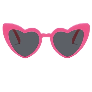 Close-up of bright pink heart-shaped plastic frames with dark grey tinted lenses