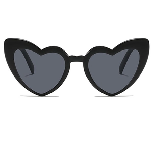 Close-up detail of black heart-shaped plastic sunglasses with dark grey lenses
