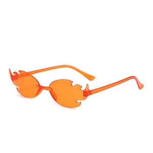 Detailed view of frameless orange flame-shaped sunglasses with slim temples and sharp edges