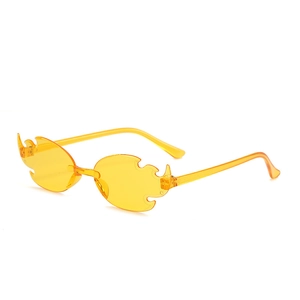 Detail of yellow transparent flame-shaped rimless sunglasses for party and festivals