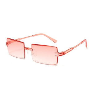 Detail of rimless rectangle sunglasses with pink gradient lenses and translucent arms