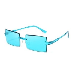 Detail view of blue translucent rimless rectangular sunglasses in a Y2K minimalist style