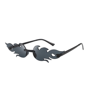 Detail view of flame-shaped rimless sunglasses with dark gray lenses and black temples