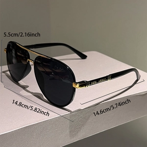 Detail view of aviator sunglasses with gold metal double bridge and text engraving on temple