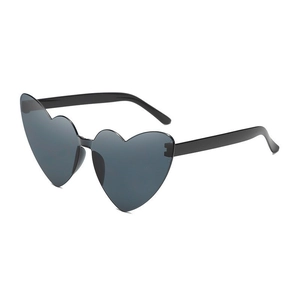 Detail view of heart-shaped sunglasses featuring black temples and dark grey lenses