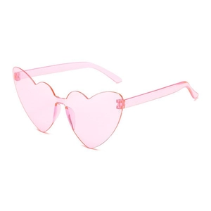 Close-up of pink heart-shaped rimless sunglasses with transparent resin frames for parties
