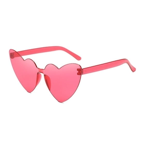 Detailed side view of pink heart-shaped rimless sunglasses for parties and fashion