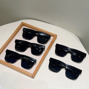 Detail view of five black square flat top sunglasses on a wooden tray for bachelorette parties