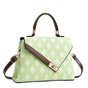 Green and beige geometric pattern crossbody handbag with brown leather trim and gold lock