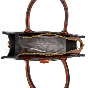Interior view of large patent leather bag showing herringbone lining and pockets