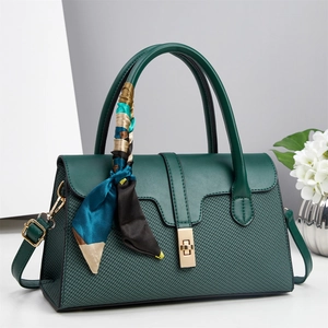 Dark green woven texture top handle bag with gold hardware and geometric scarf detail