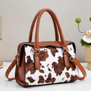 Vintage cow print tote bag with brown leather handles and large capacity storage