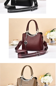 Detailed view of fashion tote bags with patterned wide straps and heart metal charms