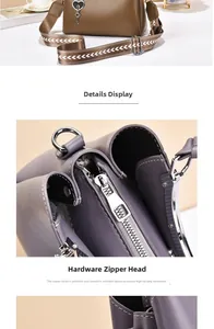 Detailed close-up of premium hardware zipper head and textured leather on ladies handbag