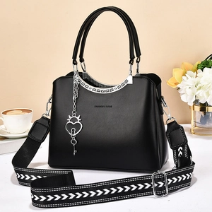 Black leather handbag with silver hardware and patterned wide strap, 2025 trendy style