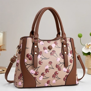 Elegant beige crossbody bag with pink cherry print and stylish brown leather trim