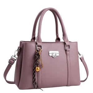 Lilac textured faux leather satchel with top handle, crossbody strap, and decorative charms