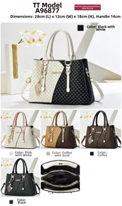 Detailed view of tote bag dimensions 28x12x18cm with stylish metal leaf pendant