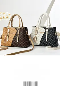 Detail of color-block monogram handbags with golden handles and pearl leaf pendant charms