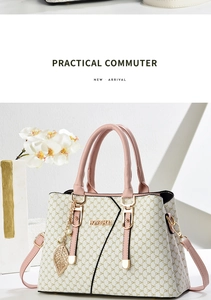 Detail of monogram tote bag with pink leather trim and elegant golden leaf pendant