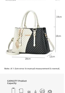 Detailed dimensions of black and white tote bag with metal leaf pendant and strap