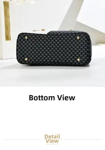 Detail of black tote bag bottom with white H pattern and four gold protective metal studs