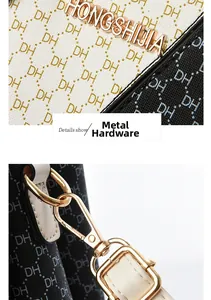 Macro shot of gold metal logo and hardware hooks on a patterned tote handbag