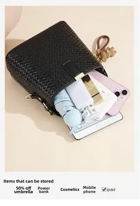 Detail showing spacious interior of black woven bucket bag filled with daily essentials