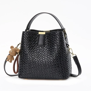Retro black woven bucket bag with gold hardware and a cute brown bear charm