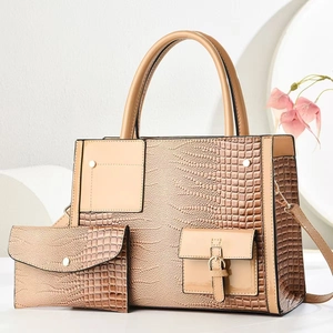 Detail of light brown crocodile pattern handbag set with luxury chain and matching wallet