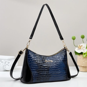 Navy blue crocodile pattern underarm bag with gold logo and elegant minimalist display