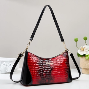 Detail of red and black snake skin texture on luxury Boston bag with golden hardware