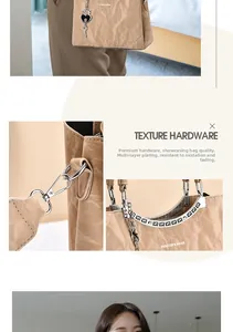 Detail of khaki pleated leather bag with silver hardware and FASHION & BAGS lettering