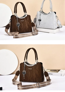 Detail view of large vintage tote bags with pleated texture and wide woven shoulder strap