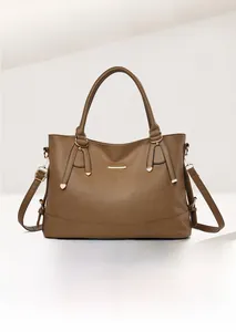 Detail view of red pebbled leather tote showing handle, strap and gold metal hardware