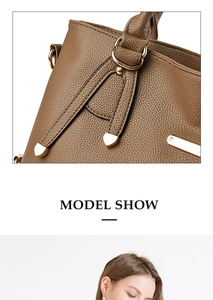 Detail of brown litchi pattern leather tote bag with gold metal hardware and stitching