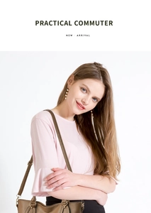 Close-up of brown pebbled leather tote bag with gold buckle on a stylish model