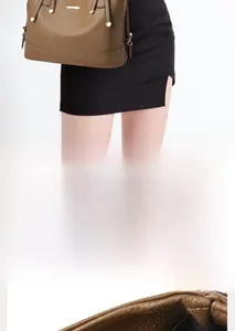 Detail of high-quality brown lychee leather tote bag with secure golden metal hardware