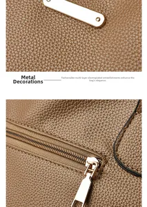 Detail of brown litchi leather texture with electroplated gold hardware and zipper