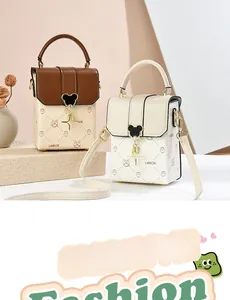 Close-up of printed PU leather mini crossbody bags featuring heart-shaped metal buckles