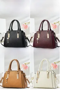 Detailed grid view showing four colors of textured leather handbags with V-shaped weaving