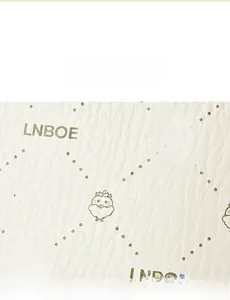 Detailed close-up of light faux leather texture with LNBOE rabbit and chick prints