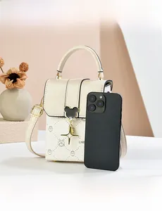 Detailed view of mini vertical crossbody bag with rabbit print and metal mouse lock