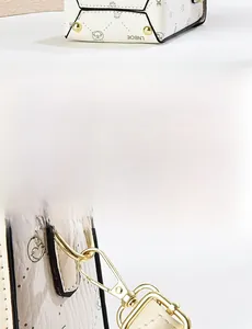 Detail view of the textured PU leather handbag bottom with gold protective metal feet